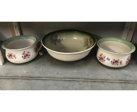 A pair of floral decorated Staffordshire chamber pots and a wash basin.