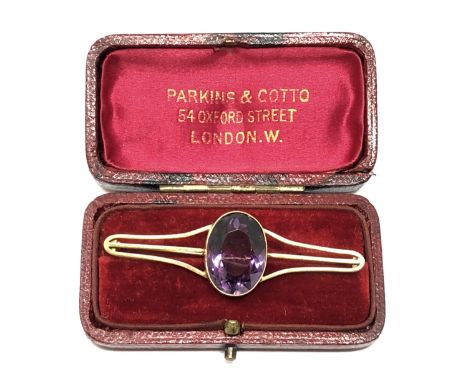 An antique gold brooch set with a large amethyst