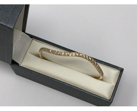 An 18ct gold bangle set with 30 diamonds, approximately 1.2ct, 8.8g.