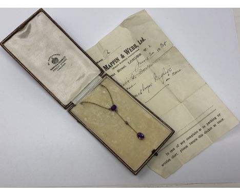 An antique gold two stone amethyst and pearl pendant on a gold chain, in original Mappin and Webb box with paperwork.