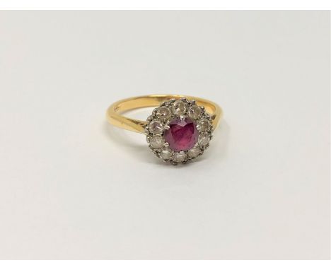 An 18ct gold ten stone diamond and ruby cluster ring, size M/N, 3.3g.