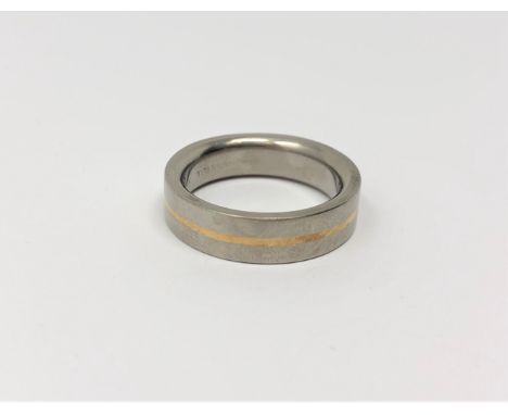 A gent's gold and titanium band ring, size T