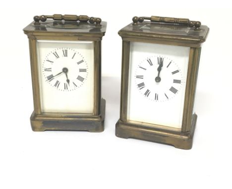 Two brass carriage clocks one seen working. Both with white enamel rectangular dials. and a leather carriage clock case.
