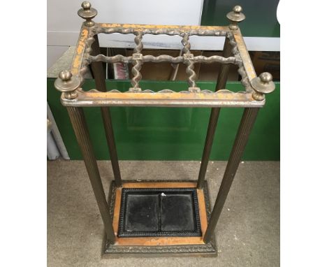 A cast iron and brass stick stand