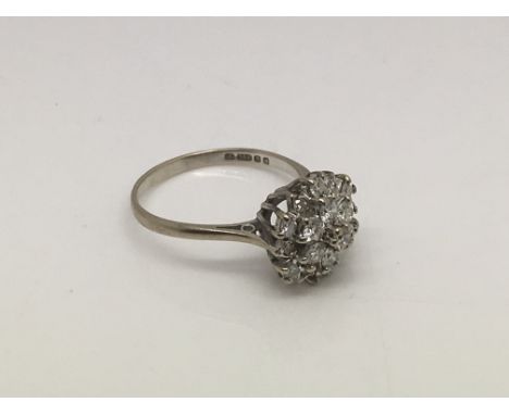 An 18ct white gold diamond cluster ring, approx 3.3g and approx size M-N.