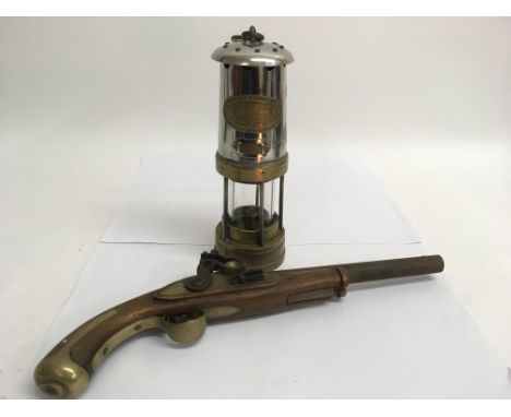 A Thomas &amp; Williams oil lamp and an old pistol