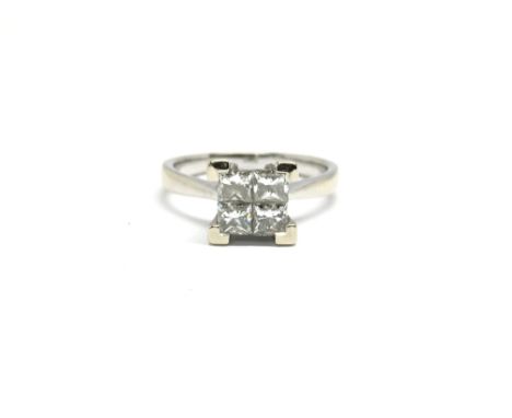 An 18ct white gold ring set with four diamonds in square formation. Total weight approx 4 grams, ring size L.