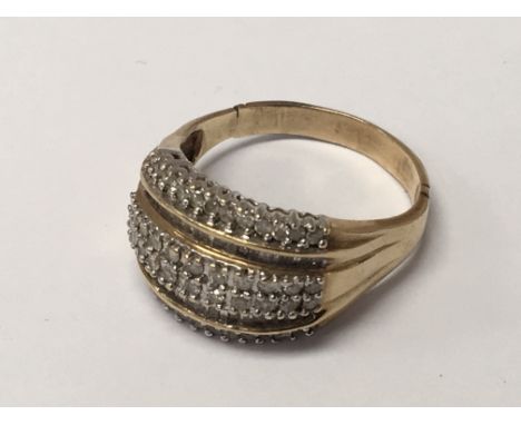 A Gents gold ring set with a row of baguette and brilliant cut diamonds ring size U.