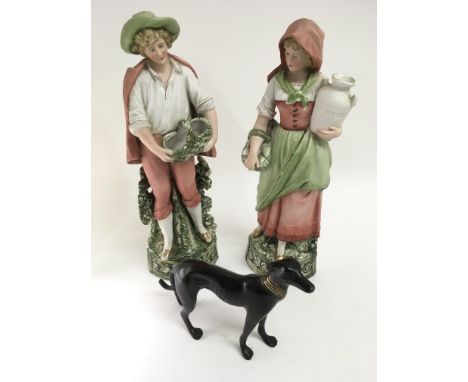 A small bronzed model of a greyhound and pair of Victorian bisque figures