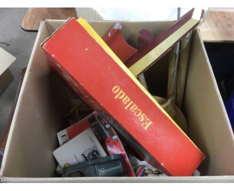 A box of model boats, toys and games equipment.