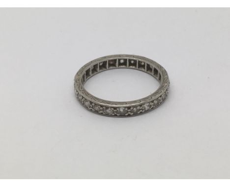 A platinum eternity ring set with small diamonds, approx 3.1g and approx size K.