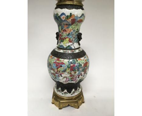 A canton style crackle ware lamp base decorated with warriors on a gilt base 54 cm
