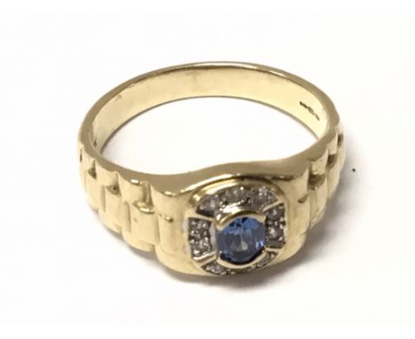 A Gents 9carat gold ring set with a blue Sapphire and small diamonds. Size U.