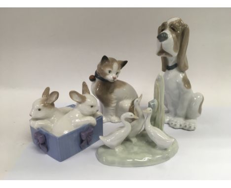 Four Nao figures of animals comprising dog, cat, rabbits and geese