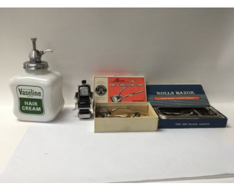 A box of vintage hairdressing tools and accessories such as razors and cups and an art of hairdressing book.