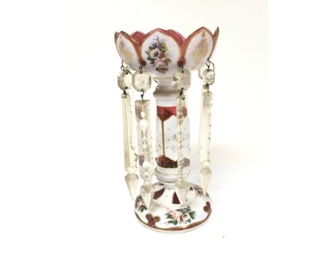 A Victorian ruby glass and opaque overlay luster painted with flowers and applied gilt.  With glass drops. Height 28cm.
