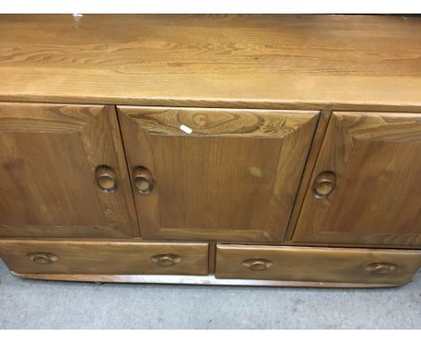 A Ercol dining set comprising drop leaf table four chairs and and sideboard