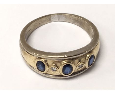 A Gents 9carat gold ring set with blue sapphire and diamonds. Ring size S-T