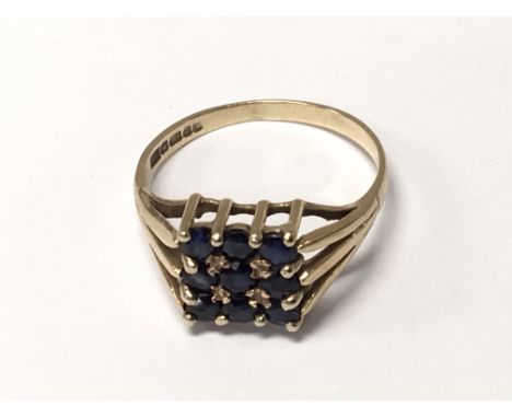 A 9carat gold ring set with a square pattern of Sapphires ring size S.