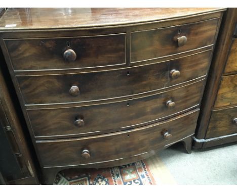 An Early Victorian Mahogany bow fronted chest of drawers fitted with two short and three long drawers on bracket feet.