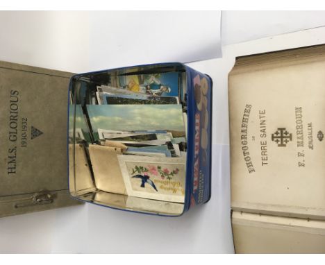 A tin of post cards a album photos of Jerusalem and a pictorial recorded of H M S Glorious