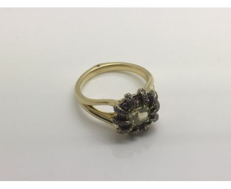 A modern 18ct gold ring set with a central yellow diamond approx 1.2ct surrounded by amethysts, approx 5.4g and approx size J