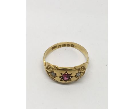 An 18ct gold ring set with small rubies and diamonds.Approx size o