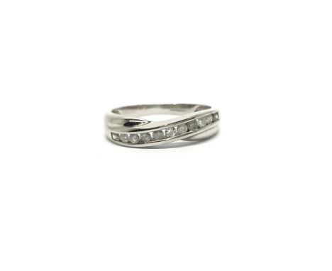 A 9ct white gold ring set with a band of diamonds, ring size approx M/N, total weight approx 2 grams.