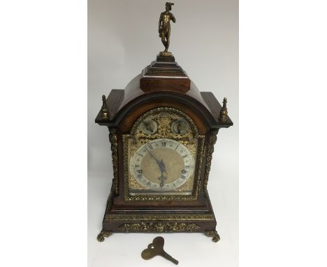 A fine quality 19th century German bracket clock by Winterhalder &amp; Hofmeier. The arched rosewood case having bevelled gla