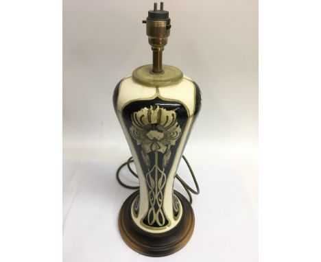 An Art Nouveau style Moorcroft lamp of tapering shape with stylised floral decoration, approx 45cm