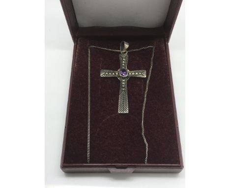 A sterling silver and amethyst crucifix pendant and chain.