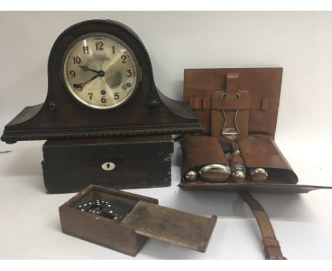 A Gentlemans Vintage shaving set with Crome fittings in a leather case, an oak mantel clock and a set of dominos