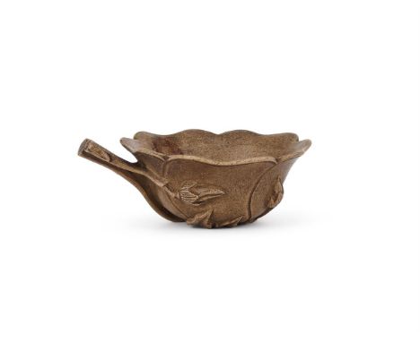 A Chinese Yixing lobed cup, 18th century, with Gongqi mark, finely potted as a flower blossom issuing from two branches with 