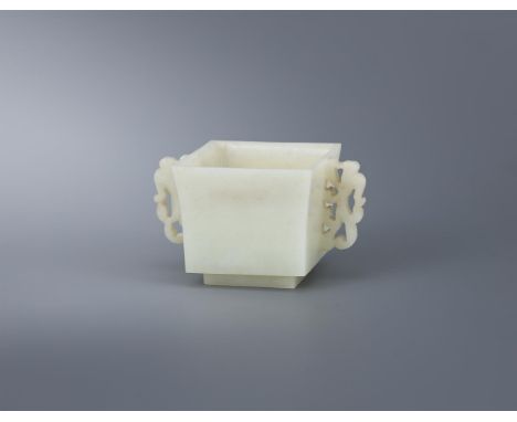 A Chinese pale celadon jade square twin-handled censer, 19th century, of square shape supported on a low foot rim, flanked wi