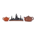 A Chinese porcelain brush rest and two Yixing teapots