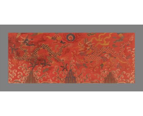 A Chinese red ground silk brocade 'Dragon' panel, Kangxi, circa 1700, with two running four-clawed dragons chasing the pearl 