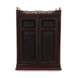 A small Chinese hongmu carved cabinet