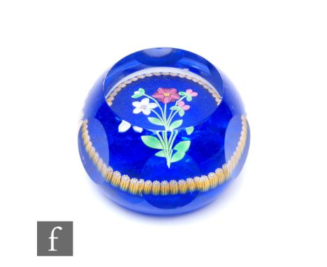 A Perthshire Collectors Club glass paperweight, internally decorated with pink and white lampwork flowers, with an outer ring