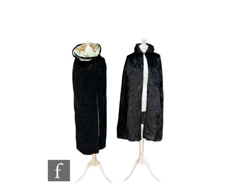 A 1920s/30s vintage long black velvet cloak, with blue silk interior and ruched collar, together with a similar 1920s/30s bla