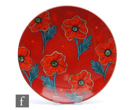 A large later boxed 20th Century Poole Pottery charger decorated with stylised poppies against a red ground, printed mark, di
