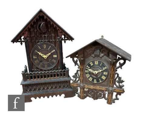 A late 19th Century carved walnut cased cuckoo clock of architectural form, on a plinth base, height 50cm, and a wall mounted