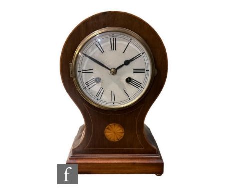 An Edwardian inlaid mahogany balloon shaped mantle clock, white dial inlaid with circular paterae, on brass ball feet, height