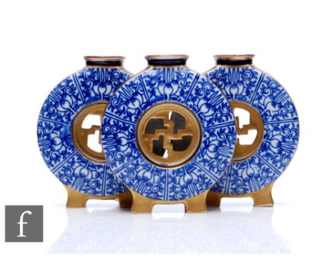 A Royal Worcester 'Royal Lily' triple posy vase, circa 1875, formed as three conjoined moon flasks with gilt fretwork centres