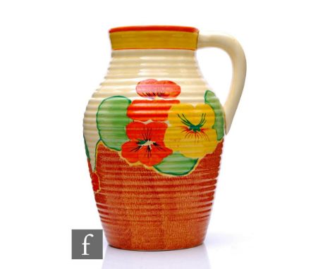 A Clarice Cliff Nasturtium single handled Lotus jug circa 1934, hand painted with stylised flowers and foliage over a stipple