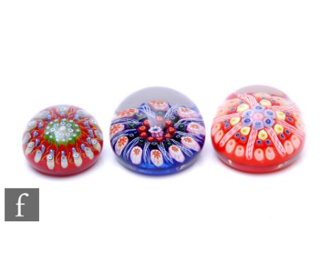 A 20th Century Strathearn glass paperweight, of domed form and internally decorated with central group of millefiori canes wi
