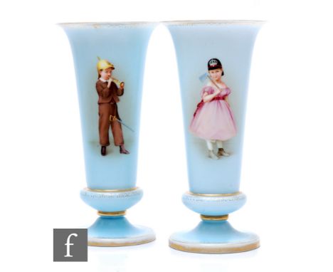 A pair of 19th Century Bohemian opal glass vases, each of footed trumpet form, each hand enamelled with a boy and girl playin