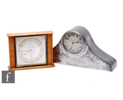 A 1930s Nelson hat type pewter hammered mantle clock and a post 1950s Kienzel mantle clock. (2) 