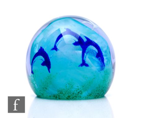 A large Caithness glass paperweight of domed form, internally decorated with dolphins over an opal swirl all cased in clear c