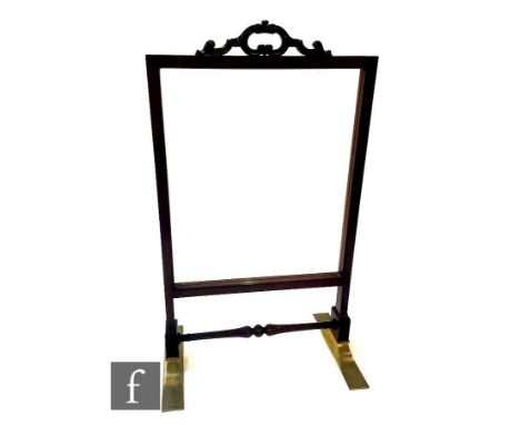 A late 19th Century mahogany floorstanding glazed firescreen, the handle of 'C' scroll design over reeded pillar design unite