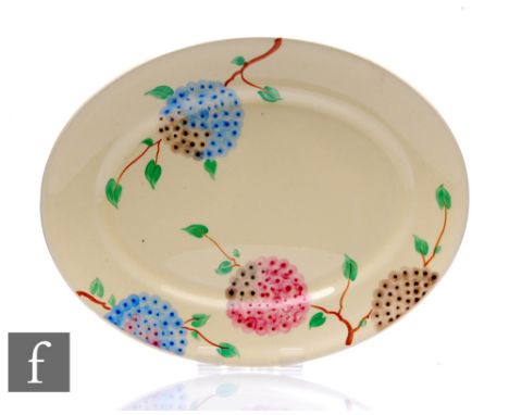 A Clarice Cliff oval meat plate circa 1935, hand painted in the Lilac pattern with stylised flowering boughs over honey glaze